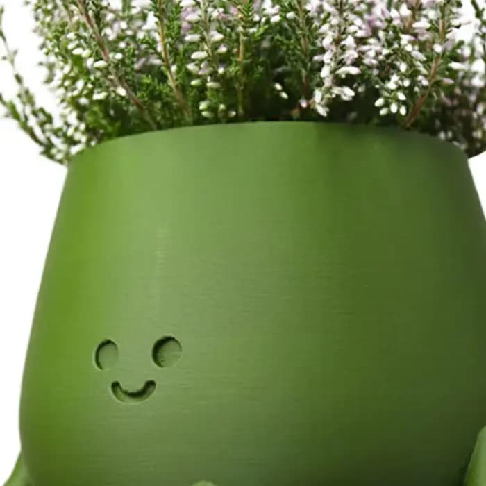 Pot de plante en résine avec visage souriant